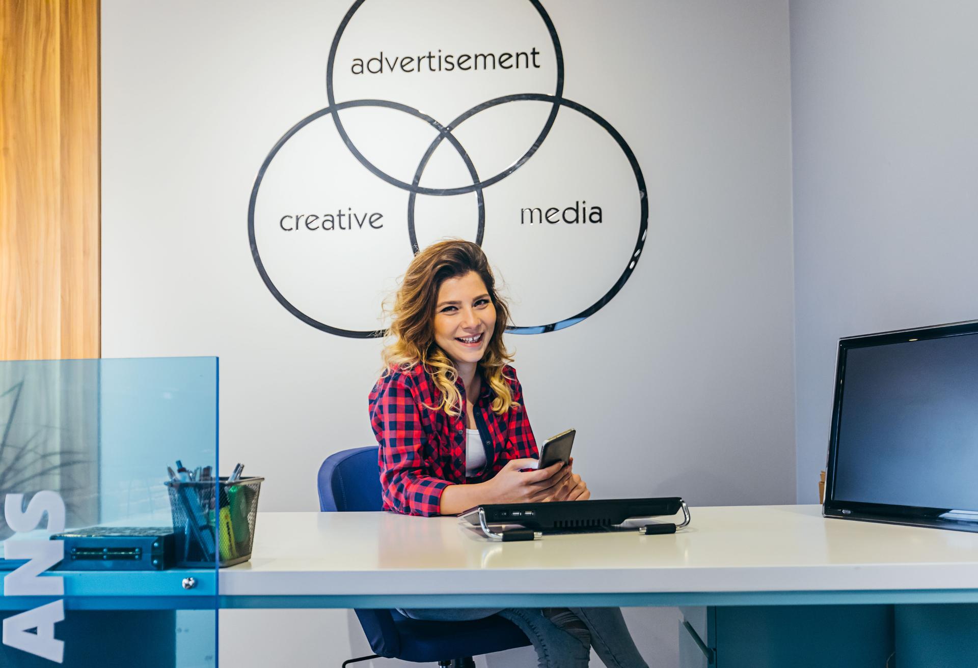 Portrait of smiling young businesswoman at creative office